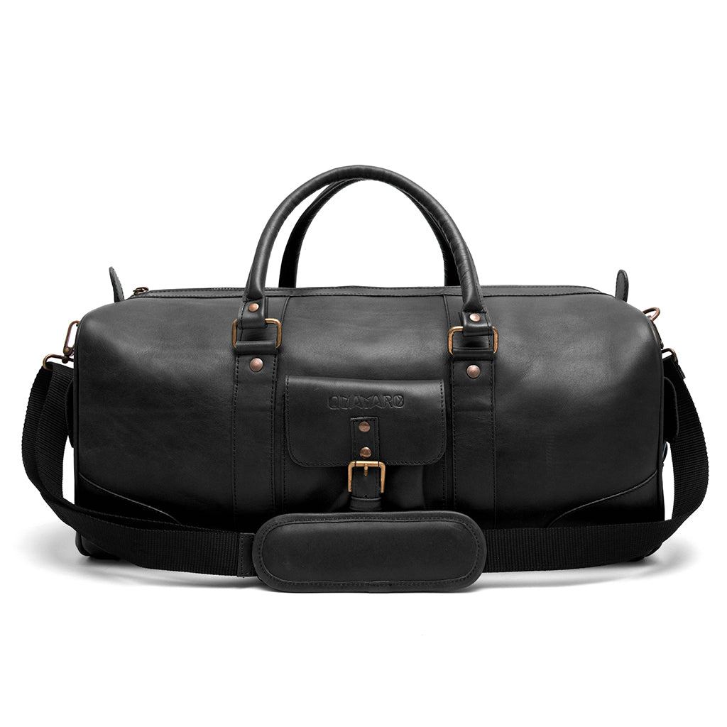 Falcon Leather Duffle Bag on a bench, showing full-grain leather and compact form.